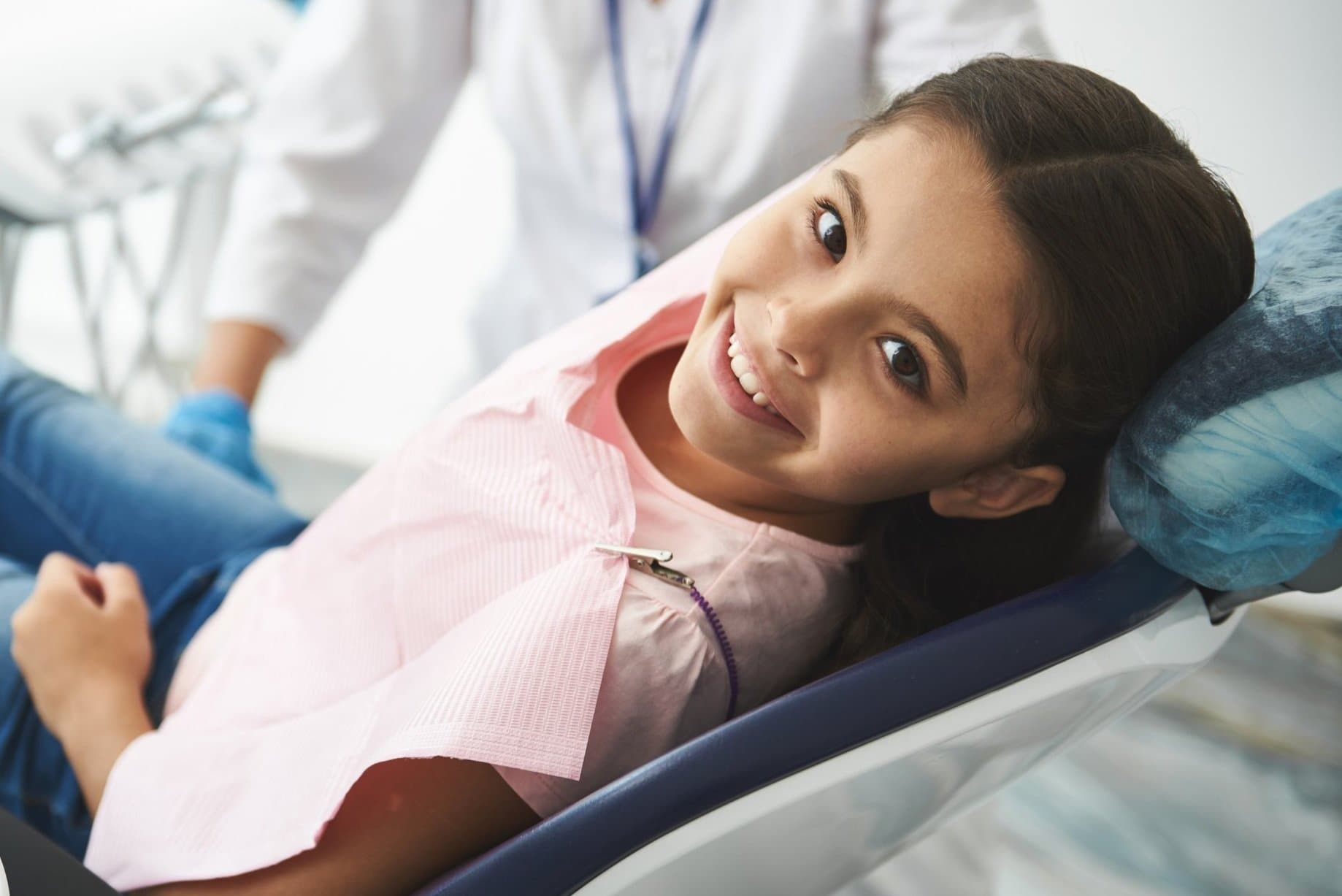 A child smiling in the dental chair before an Invisalign First assessment at Align Dental Surgery, Orchard Road