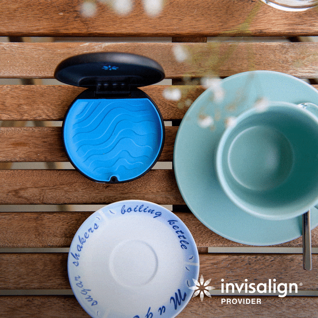An Invisalign Provider lifestyle animation of an open aligner case beside a teacup and saucer on a wooden table, a reminder to remove the appliance before hot drinks, at Align Dental Surgery